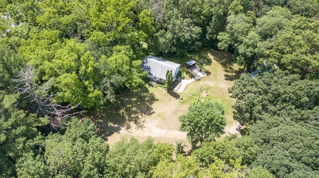 drone / aerial view with a wooded view