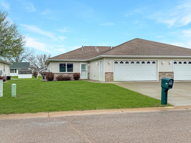 single story home featuring brick siding, a garage, roof with shingles, a front lawn, and concrete driveway