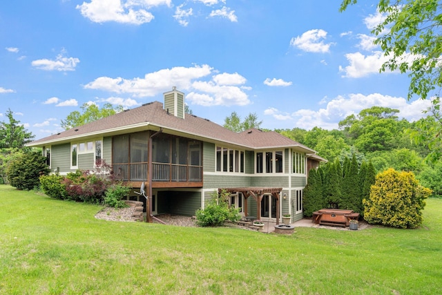 374 Indigo Trl, Troy Twp, WI 54022 - rear view of property featuring a hot tub, a sunroom, a patio area, a chimney, and a yard