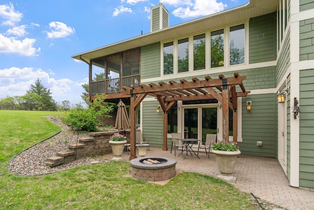 374 Indigo Trl, Troy Twp, WI 54022 - back of property featuring an outdoor fire pit, a patio, a yard, a sunroom, and a chimney
