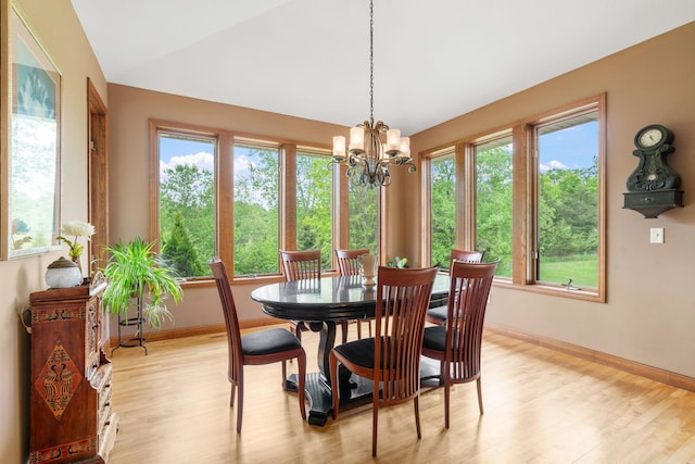 374 Indigo Trl, Troy Twp, WI 54022 - dining area featuring light wood-type flooring, baseboards, a chandelier, and vaulted ceiling
