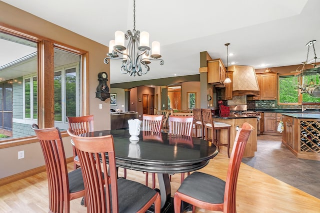 374 Indigo Trl, Troy Twp, WI 54022 - dining space featuring a chandelier, light wood-style flooring, and baseboards