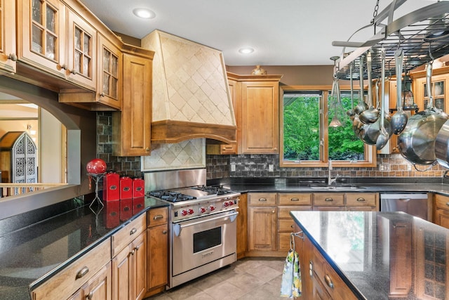 374 Indigo Trl, Troy Twp, WI 54022 - kitchen featuring appliances with stainless steel finishes, a sink, custom range hood, glass insert cabinets, and backsplash