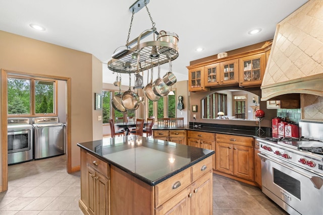 374 Indigo Trl, Troy Twp, WI 54022 - kitchen featuring washer and dryer, luxury range, custom exhaust hood, recessed lighting, and a center island