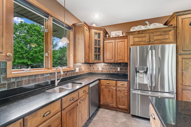 374 Indigo Trl, Troy Twp, WI 54022 - kitchen with stainless steel appliances, a sink, brown cabinetry, glass insert cabinets, and decorative backsplash