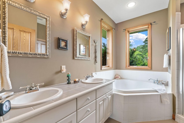 374 Indigo Trl, Troy Twp, WI 54022 - full bathroom featuring a bath, double vanity, an enclosed shower, and recessed lighting