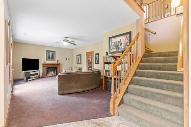 374 Indigo Trl, Troy Twp, WI 54022 - living area with carpet floors, stairway, a glass covered fireplace, and ceiling fan