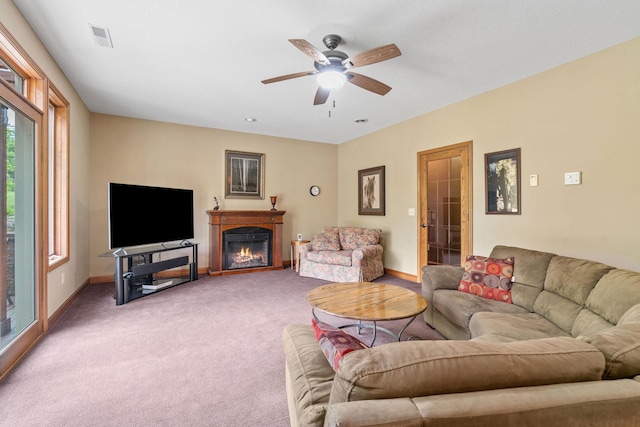 374 Indigo Trl, Troy Twp, WI 54022 - carpeted living room with ceiling fan, baseboards, and a glass covered fireplace