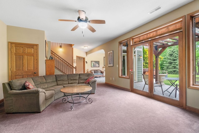 374 Indigo Trl, Troy Twp, WI 54022 - living room with carpet flooring, stairway, arched walkways, ceiling fan, and baseboards