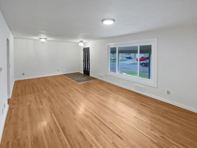 1005 Honeysuckle Ln, Farmington, MN 55024 - unfurnished living room with baseboards and light wood-style floors