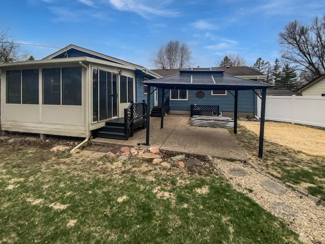1005 Honeysuckle Ln, Farmington, MN 55024 - rear view of house featuring fence, a patio, and a sunroom