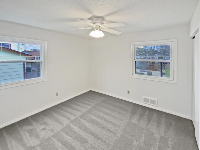 1005 Honeysuckle Ln, Farmington, MN 55024 - carpeted spare room with a ceiling fan, visible vents, a textured ceiling, and baseboards