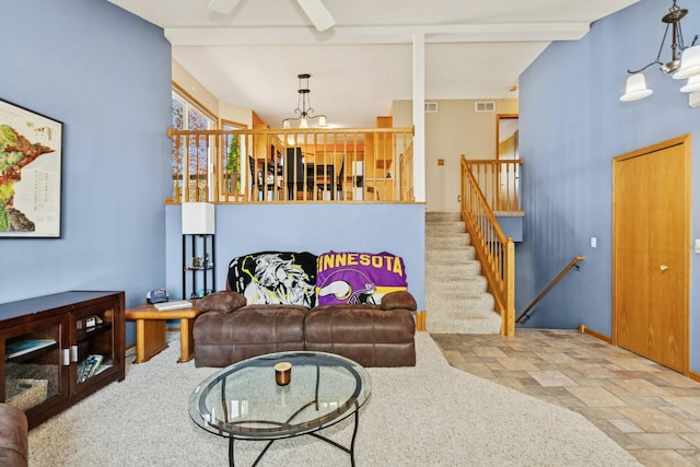 402 13th Ave NE, Buffalo, MN 55313 - living room featuring a chandelier, stone finish floors, stairs, a ceiling fan, and baseboards