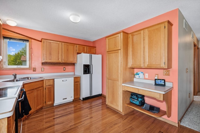 402 13th Ave NE, Buffalo, MN 55313 - kitchen featuring white appliances, light wood-style flooring, light countertops, a textured ceiling, and a sink