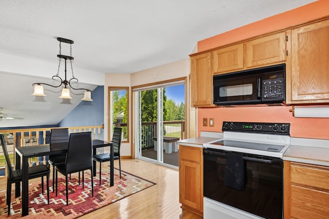 402 13th Ave NE, Buffalo, MN 55313 - kitchen featuring black microwave, electric stove, light wood-style flooring, and light countertops