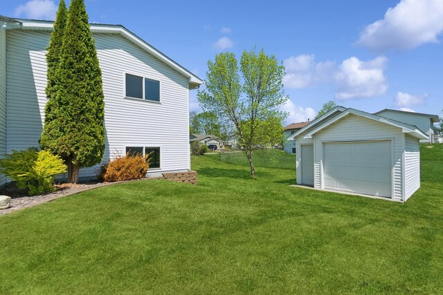 402 13th Ave NE, Buffalo, MN 55313 - view of grassy yard with a detached garage and an outdoor structure