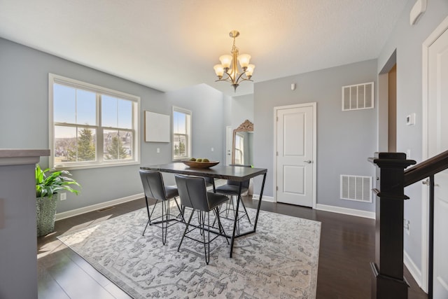 4343 Corn Silk Ln, Woodbury, MN 55129 - dining room featuring a chandelier and dark wood-style floors