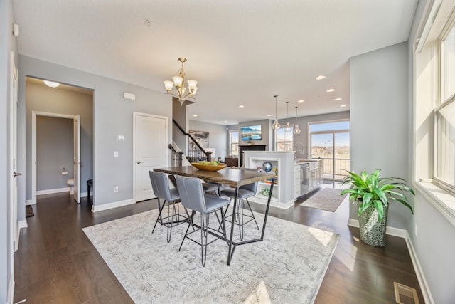 4343 Corn Silk Ln, Woodbury, MN 55129 - dining room with a chandelier, stairs, dark wood-type flooring, and recessed lighting