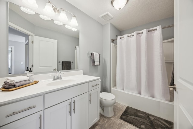 4343 Corn Silk Ln, Woodbury, MN 55129 - bathroom featuring vanity, shower / bath combo with shower curtain, and a textured ceiling