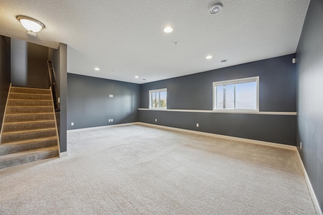 4343 Corn Silk Ln, Woodbury, MN 55129 - carpeted spare room with stairs, a textured ceiling, and recessed lighting
