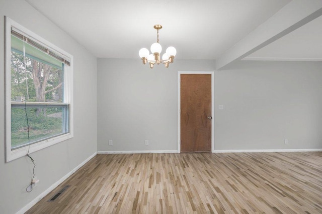 314 Orchard St N, Northfield, MN 55057 - unfurnished room featuring a chandelier, wood finished floors, and baseboards