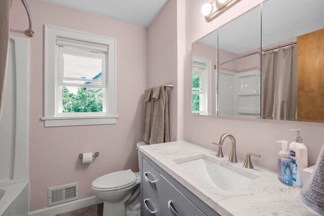 314 Orchard St N, Northfield, MN 55057 - full bathroom featuring healthy amount of natural light, toilet, vanity, and baseboards