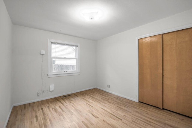 314 Orchard St N, Northfield, MN 55057 - unfurnished bedroom with light wood-style flooring, baseboards, and a closet