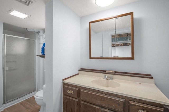 314 Orchard St N, Northfield, MN 55057 - full bath featuring toilet, a stall shower, vanity, and wood finished floors