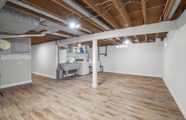 314 Orchard St N, Northfield, MN 55057 - below grade area featuring baseboards, a sink, and wood finished floors