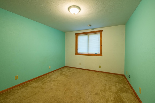 2374 320th St, Forest Twp, WI 54005 - spare room with a textured ceiling, carpet floors, and baseboards