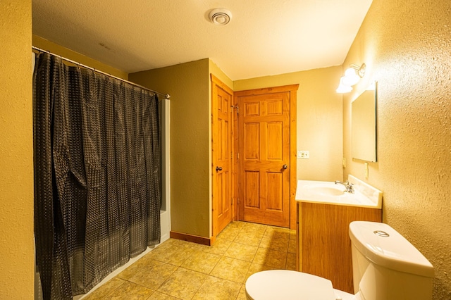 2374 320th St, Forest Twp, WI 54005 - full bathroom with tile patterned flooring, toilet, a textured wall, vanity, and visible vents