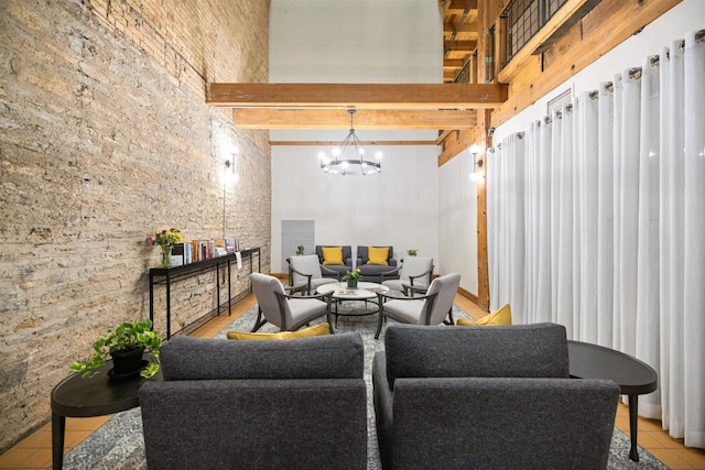 living room with beamed ceiling, a chandelier, tile patterned floors, and a high ceiling
