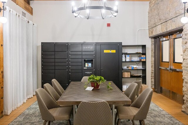 dining area featuring tile patterned floors and a chandelier