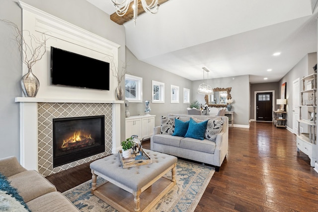 living room featuring recessed lighting, wood finished floors, a chandelier, a fireplace, and baseboards