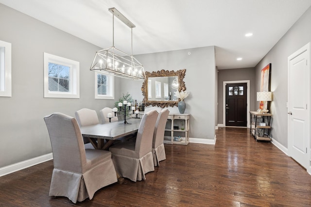 dining space featuring a chandelier, baseboards, wood finished floors, and recessed lighting