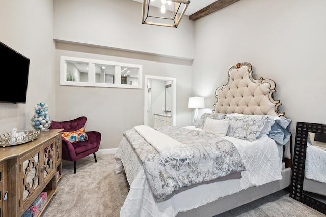 bedroom with carpet, beamed ceiling, and a high ceiling