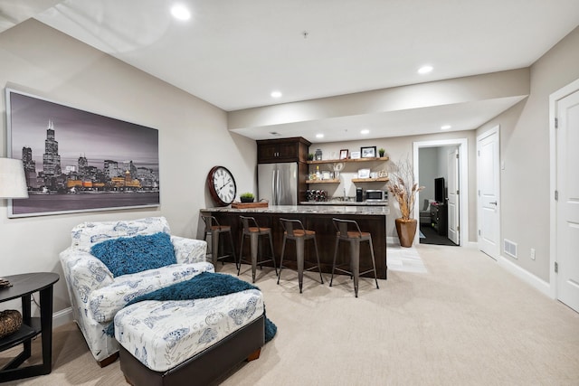 bar with recessed lighting, appliances with stainless steel finishes, indoor wet bar, baseboards, and visible vents