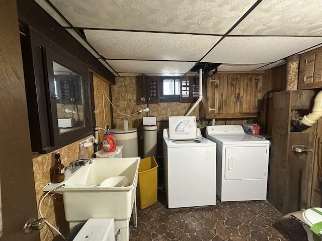 laundry room featuring washer and clothes dryer, laundry area, and a sink