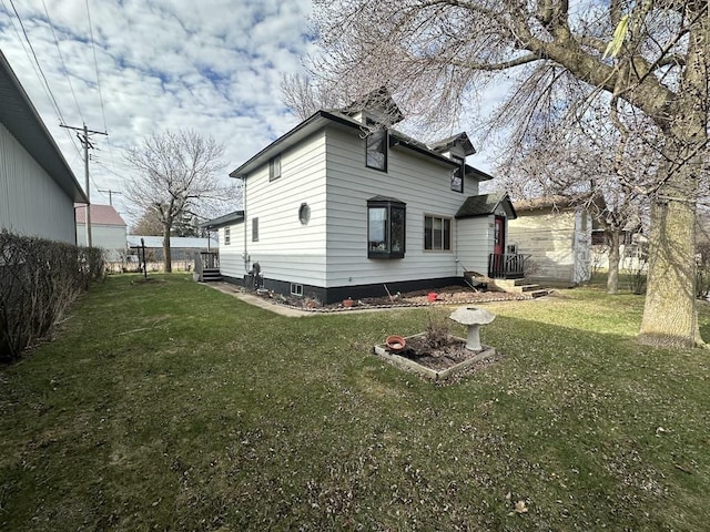 back of house with a yard and fence