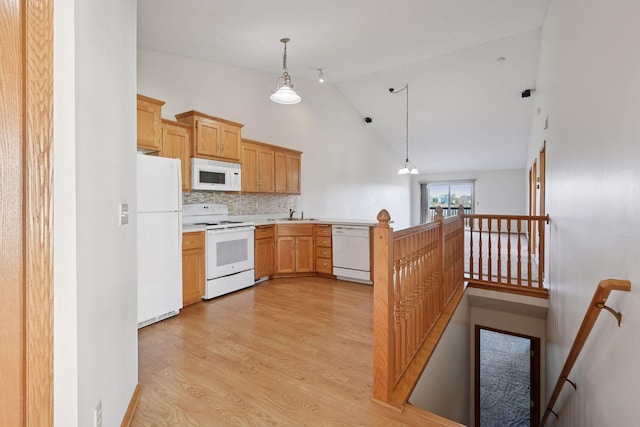 kitchen featuring hanging light fixtures, a sink, white appliances, high vaulted ceiling, and light wood-type flooring