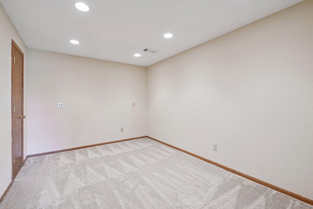 unfurnished room with baseboards, light carpet, recessed lighting, and visible vents