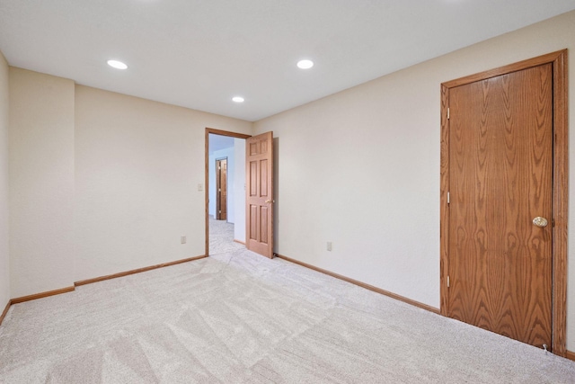 unfurnished room featuring carpet floors, recessed lighting, and baseboards