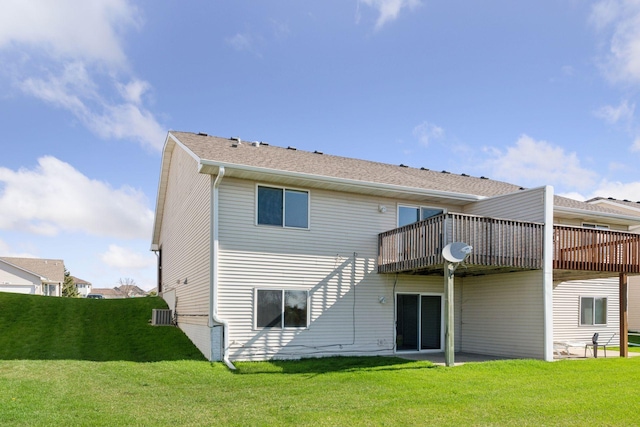 rear view of house with a lawn and a wooden deck