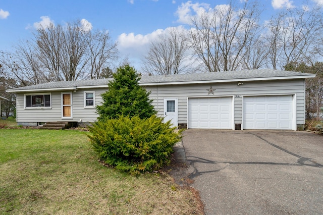 ranch-style home with a front lawn, driveway, and an attached garage