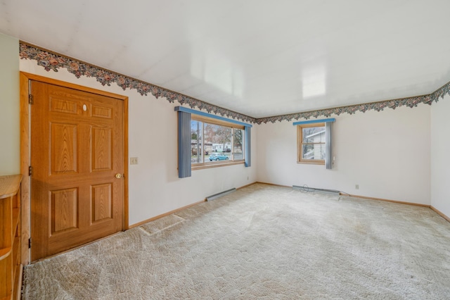 carpeted spare room featuring visible vents and baseboards