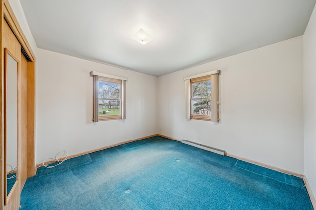 unfurnished bedroom featuring multiple windows, baseboard heating, carpet floors, and baseboards