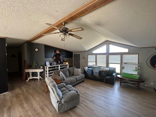 living room with lofted ceiling, a textured ceiling, wood finished floors, and ceiling fan