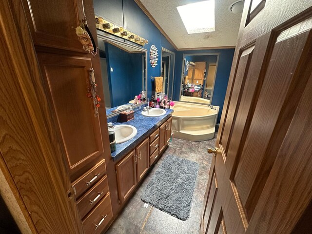 full bath featuring a textured ceiling, a bathing tub, lofted ceiling, and a sink
