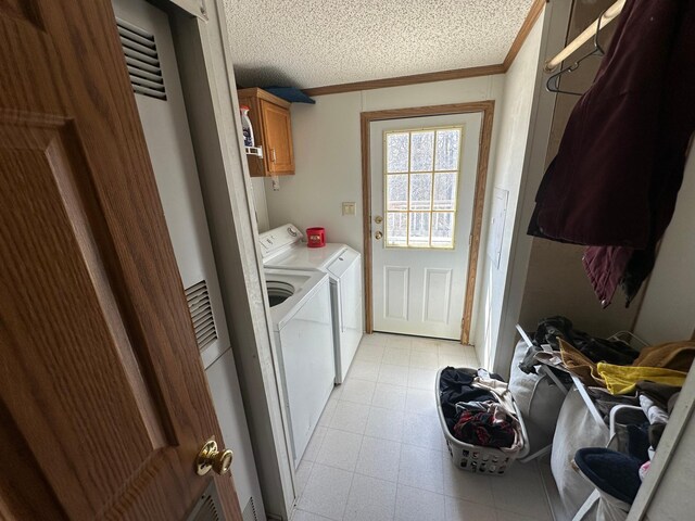 laundry area featuring cabinet space, a heating unit, separate washer and dryer, crown molding, and a textured ceiling