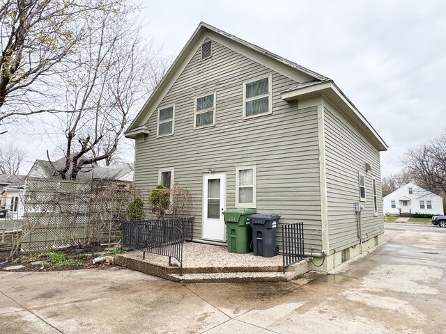 rear view of house featuring fence
